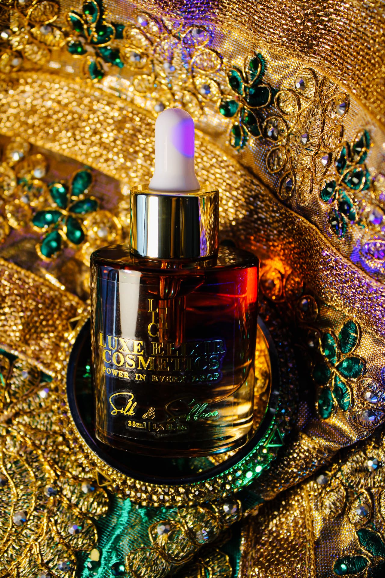 Silk & Saffron perfume oil bottle by Luxe Elixir Cosmetics Perfume Oils on gold embroidered fabric